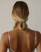 view of a person with champagne silk scrunchie ponytail