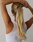view of a person with black silk scrunchie ponytail