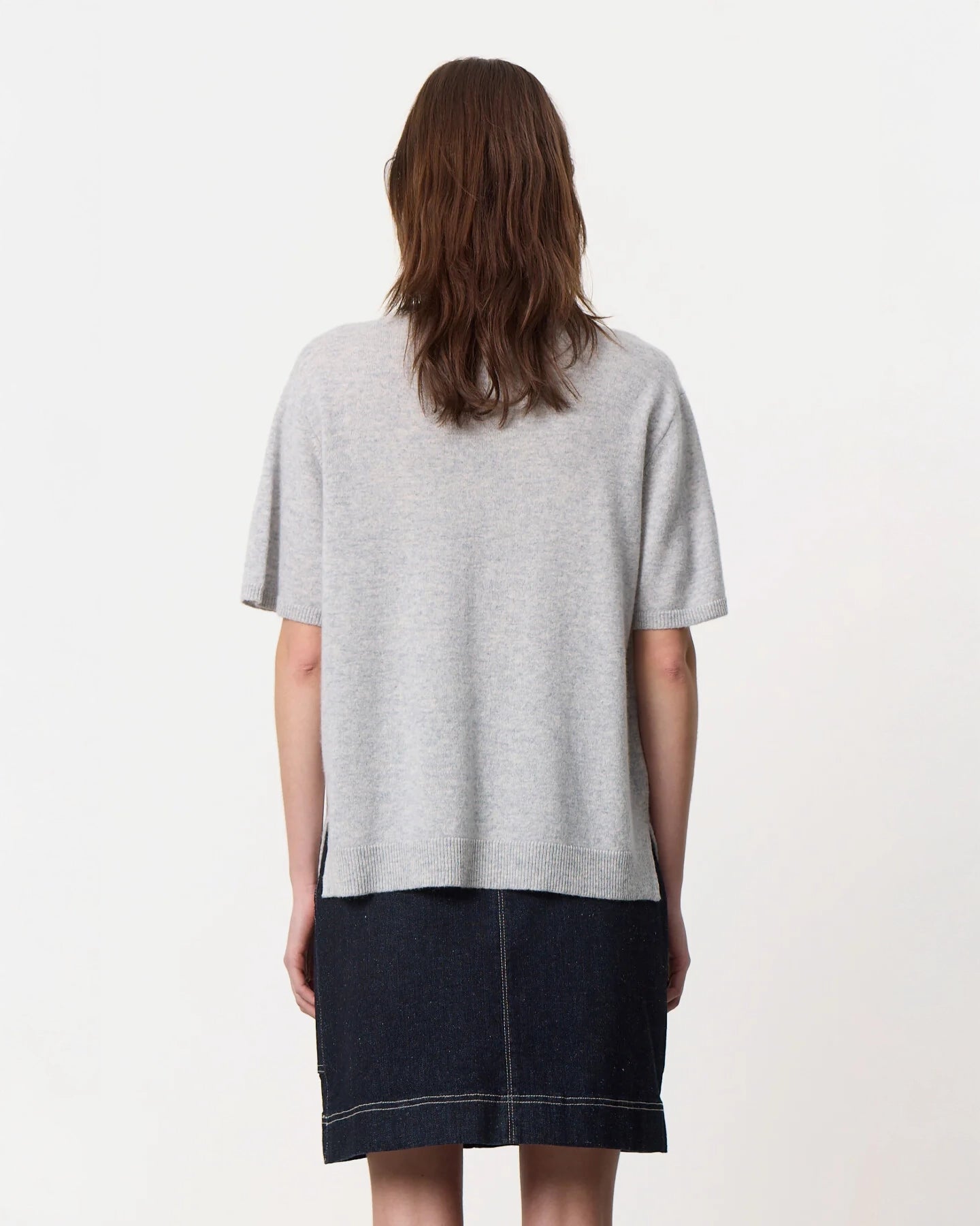 a woman wearing a crew neck oversized cashmere tee in grey
