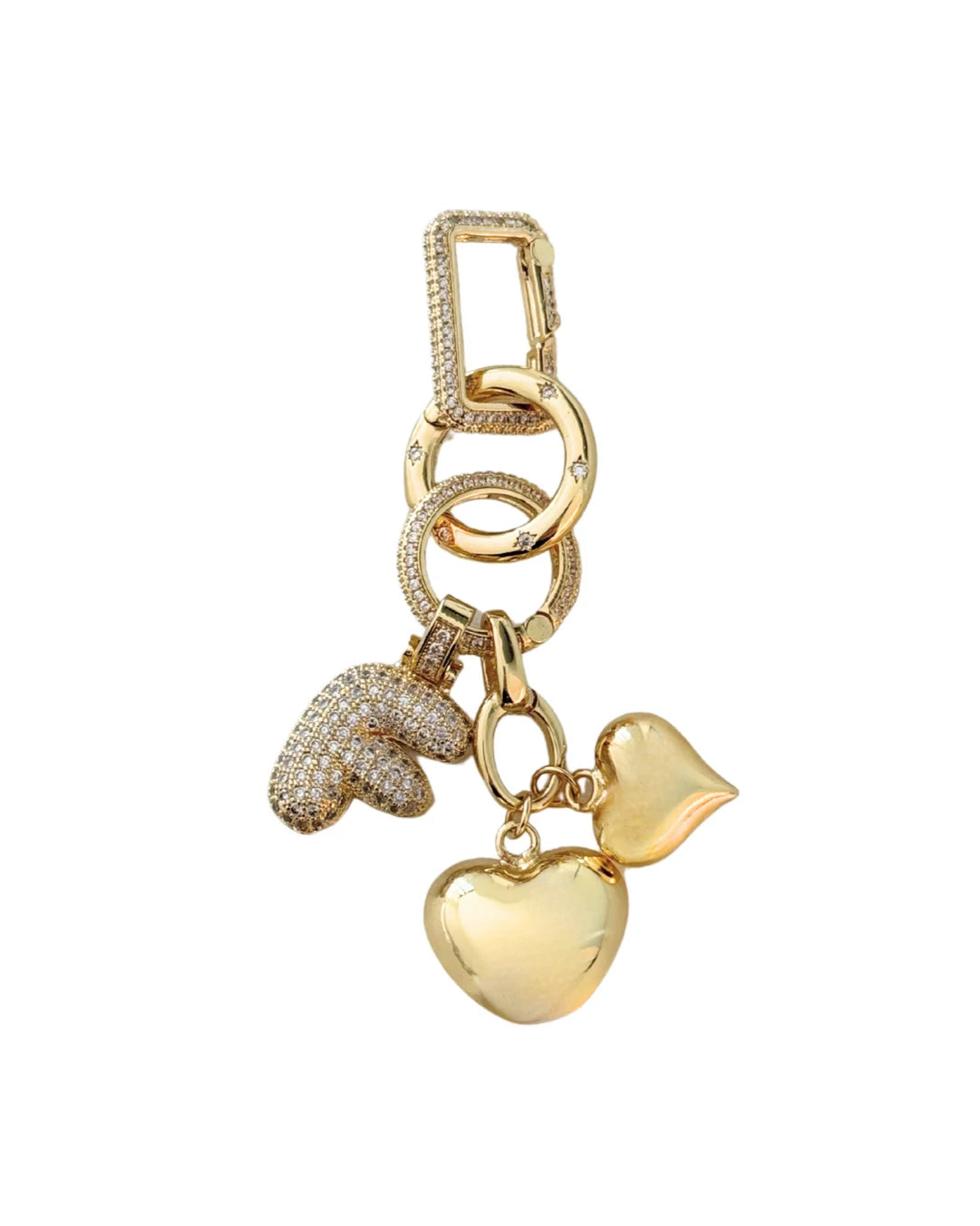 a picture of a gold bag charm with heart charms and a letter
