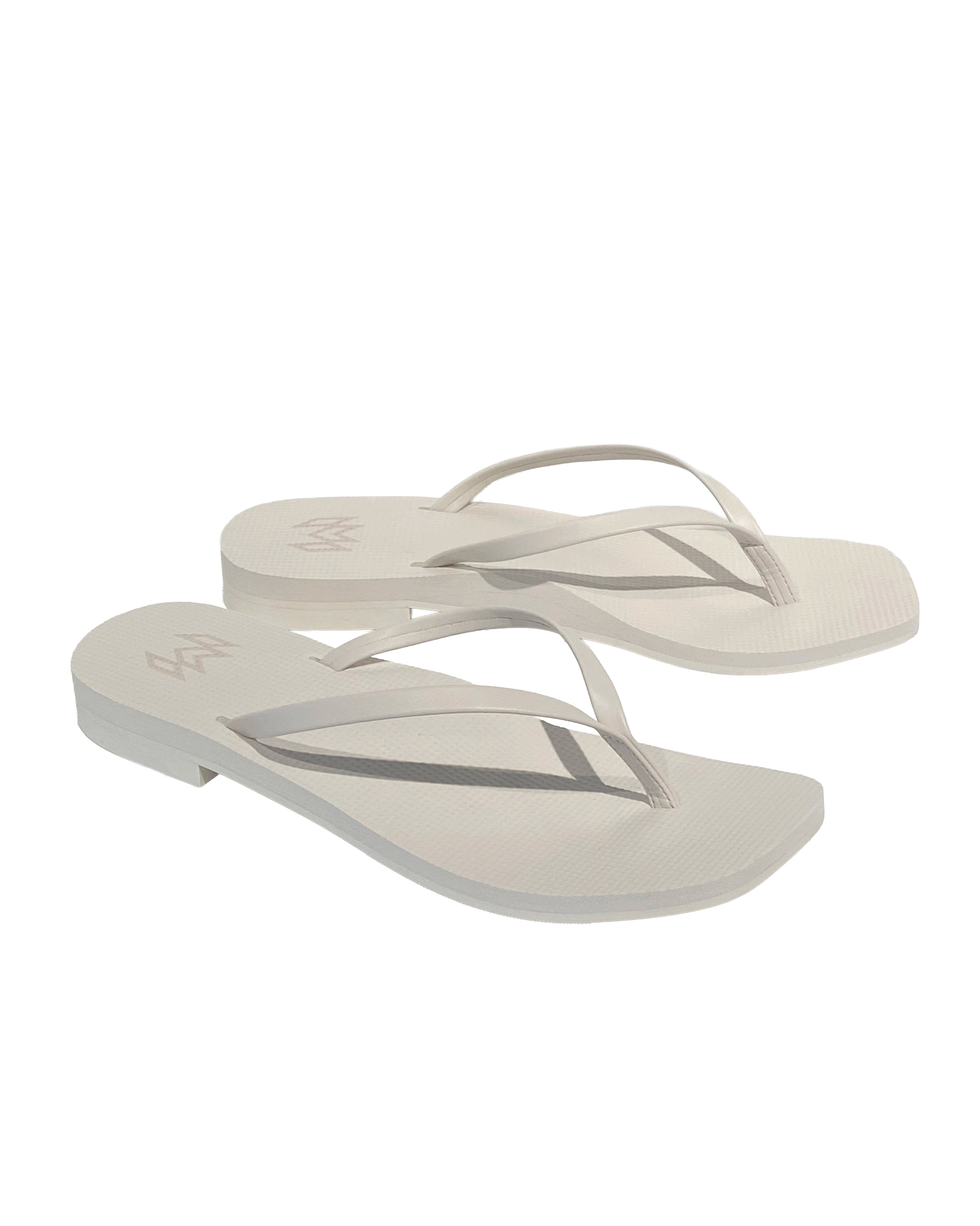 Pair of white flip-flops with a slight heel
