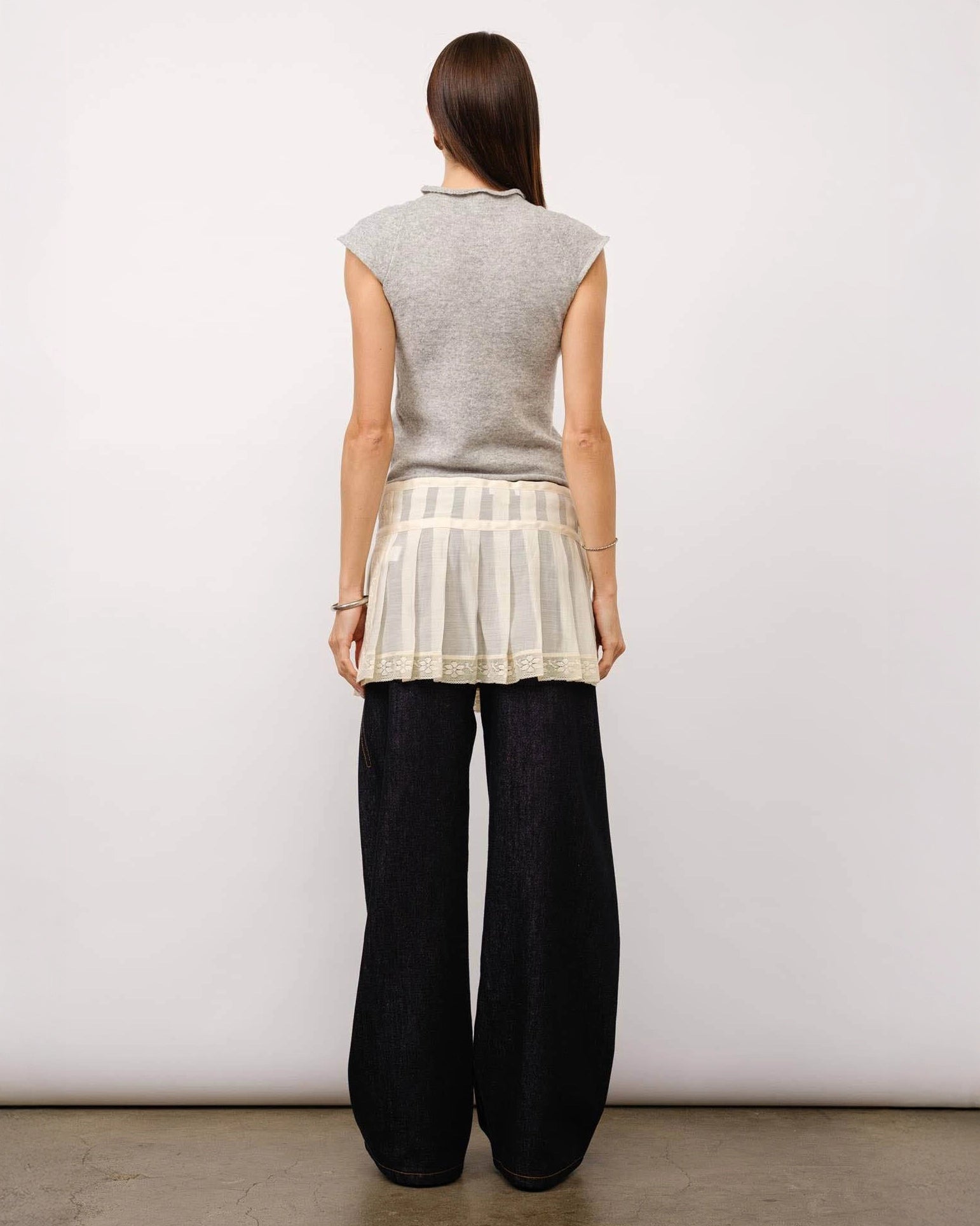 A model wearing a grey melange cap sleeve top with a fitted silhouette