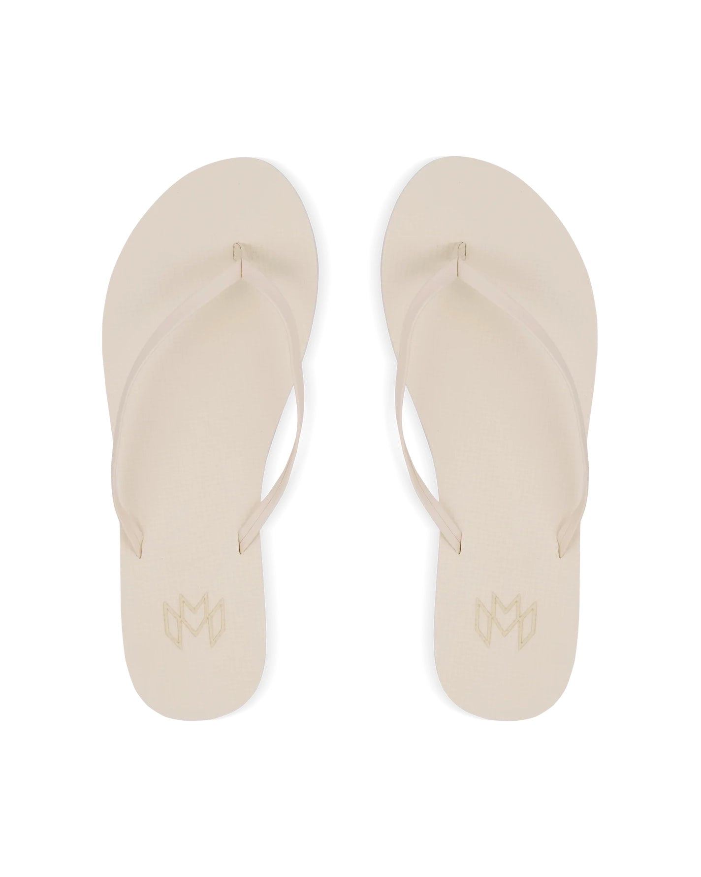 A pair of cream flip flops, viewed from above.