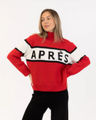 Woman wearing a red sweater with black and white accents with 'Après' on it