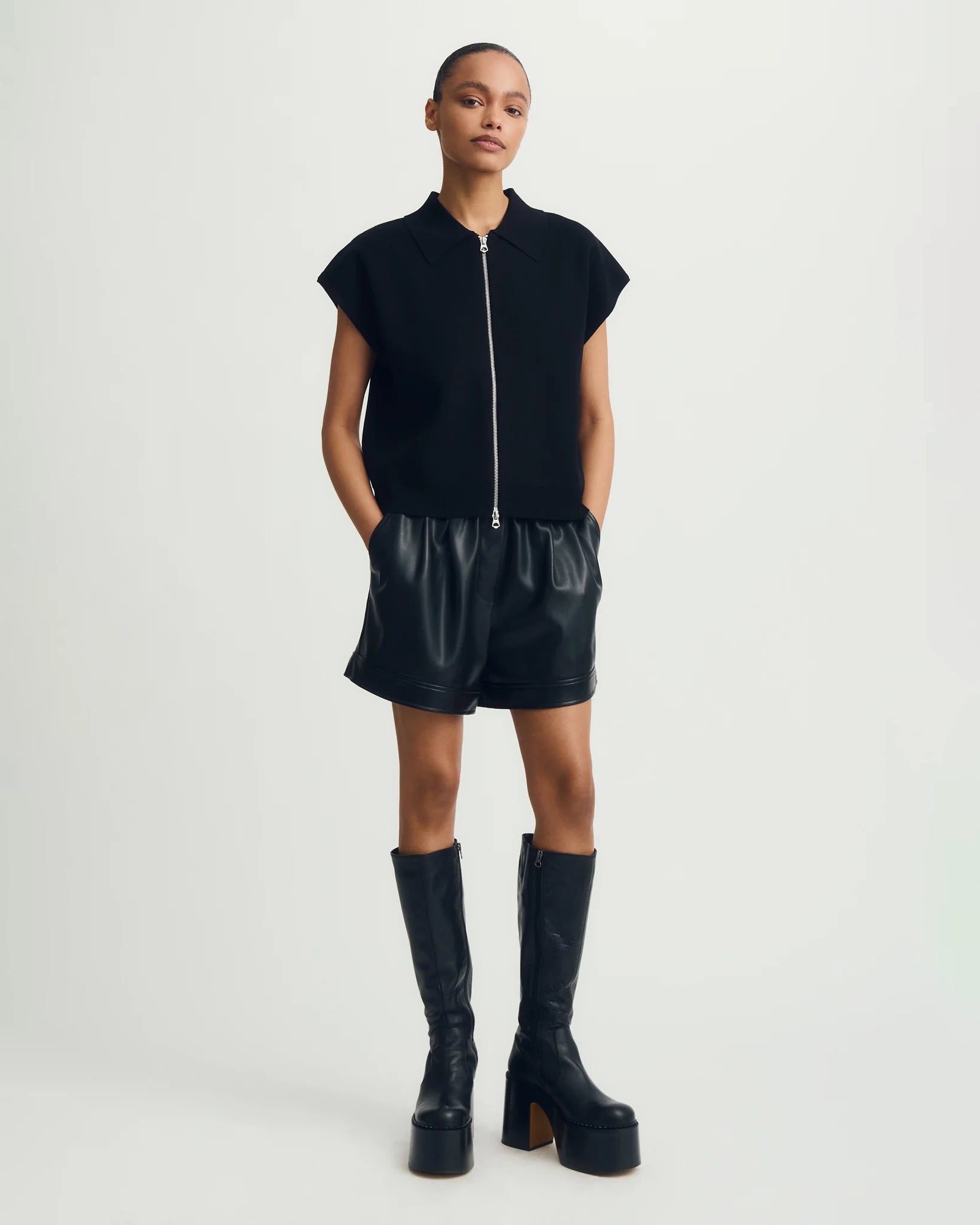 a woman wears a black tee zip up sweater tee