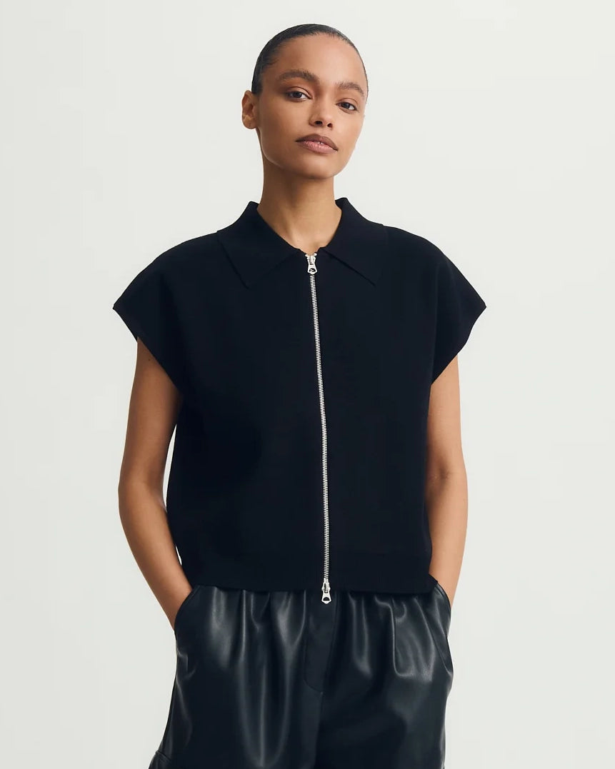 a woman wears a black tee zip up sweater tee