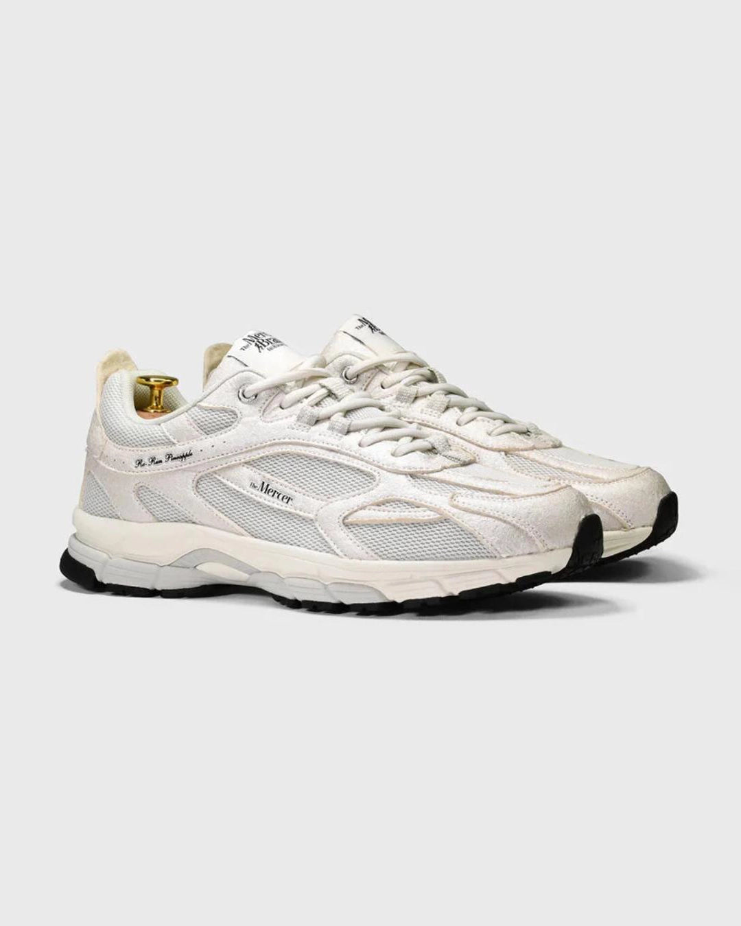 white sneakers with mercer branding on the side