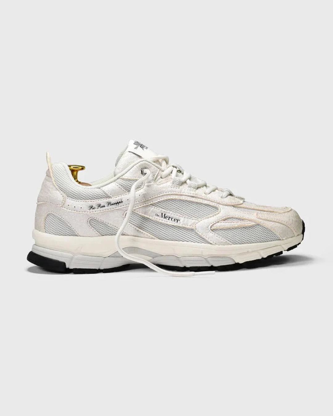 a white sneaker with mercer branding on the side