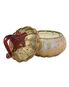 candle in a pumpkin shaped glass container