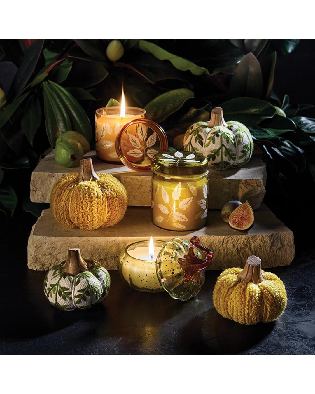 candle in a pumpkin shaped glass container