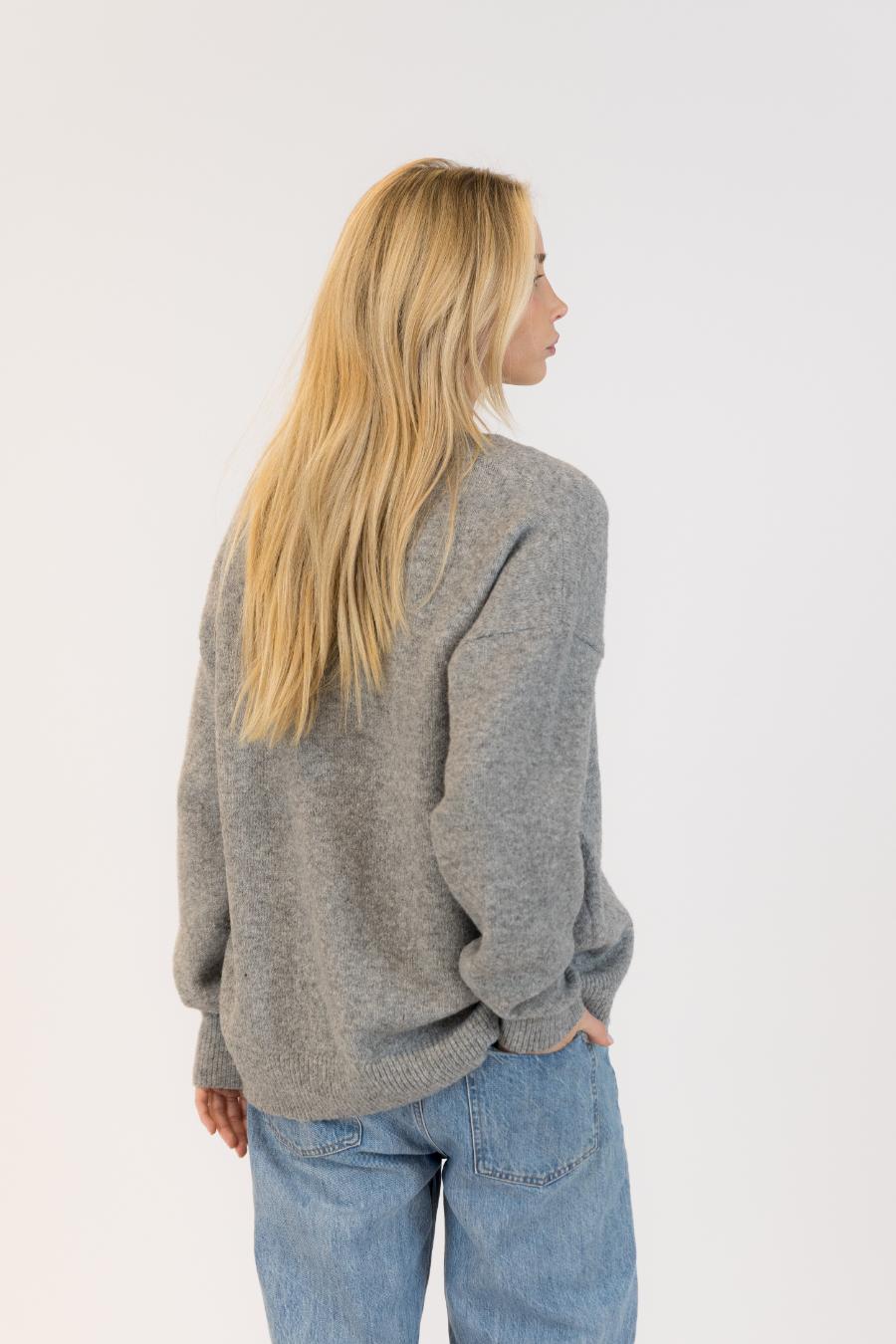 back view of a grey cardigan with silver buttons