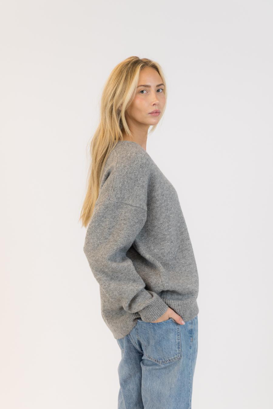 side view of a grey cardigan with silver buttons