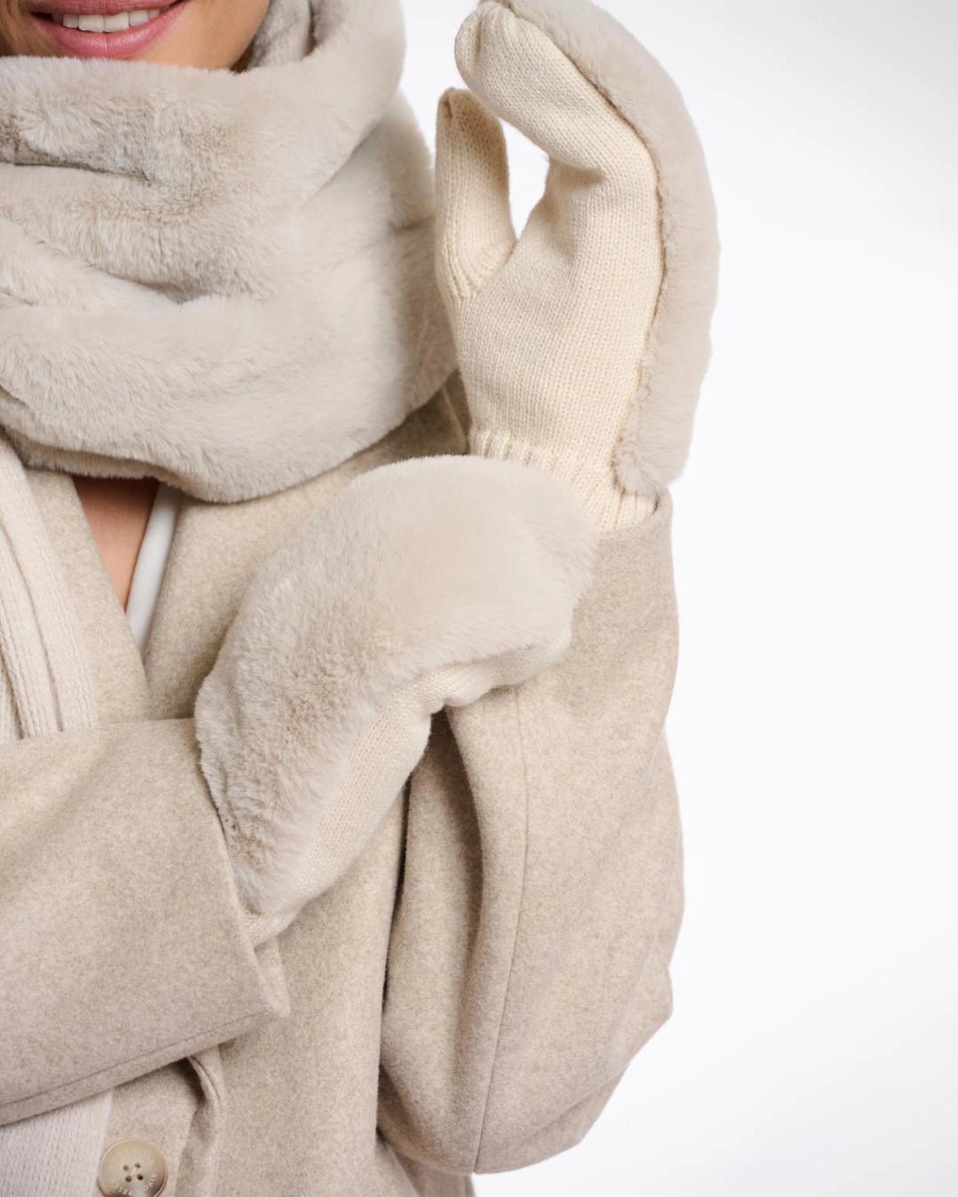 woman wearing faux fur beige mittens