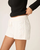 a woman wears white cable knit chenille loungewear shorts by PJ Salvage