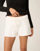 a woman wears white cable knit chenille loungewear shorts by PJ Salvage