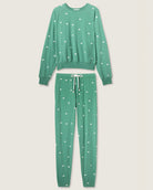 a green pajama set with white bears embroidered all over