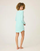 a woman wears mint green sleepshirt with a pointelle texture