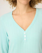 a woman wears mint green sleepshirt with a pointelle texture