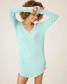 a woman wears mint green sleepshirt with a pointelle texture