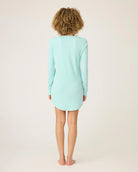 a woman wears mint green sleepshirt with a pointelle texture