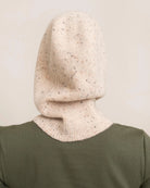 woman wearing a light cream knitted hood hat
