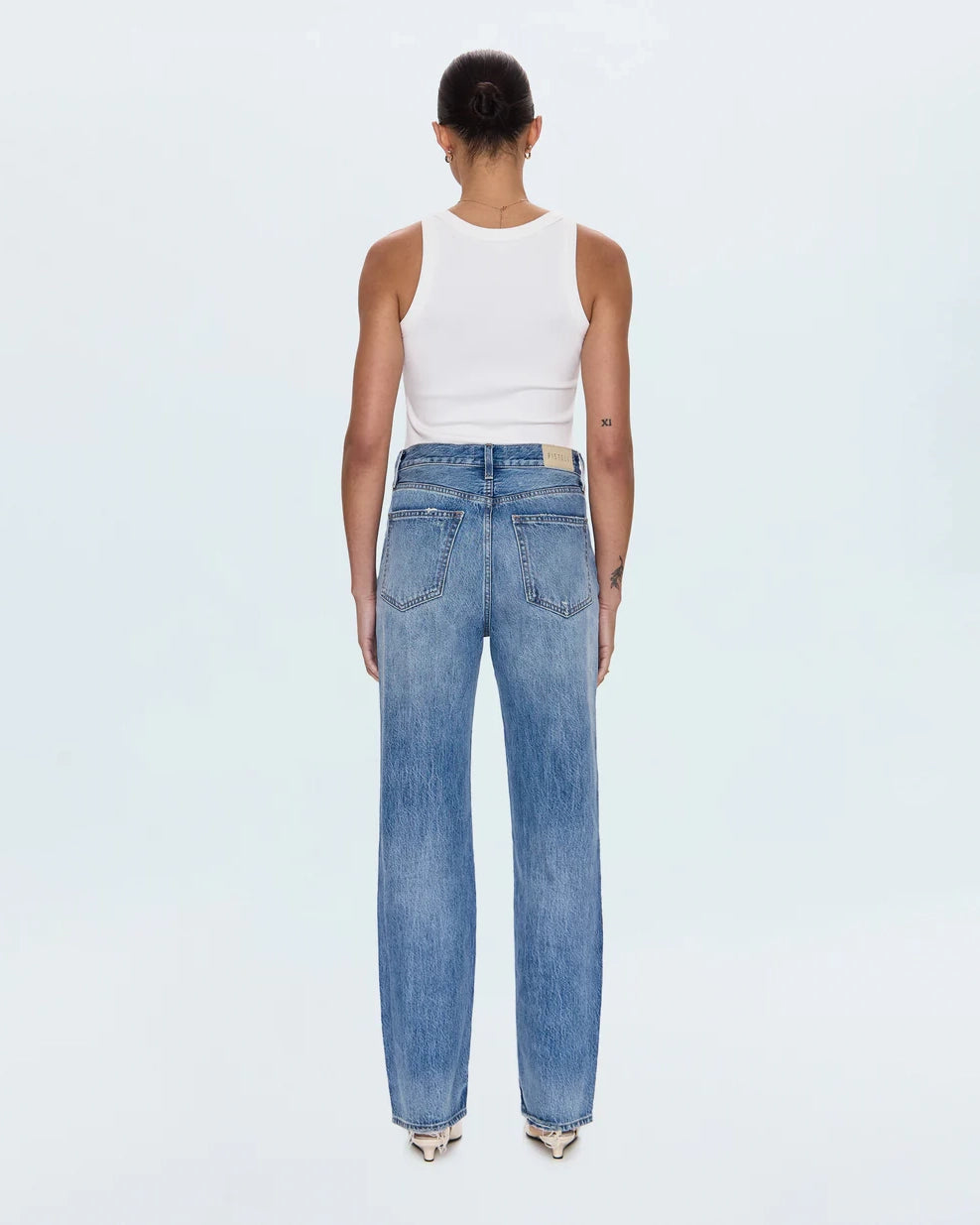 a woman wearing high rise straight jeans from Pistola