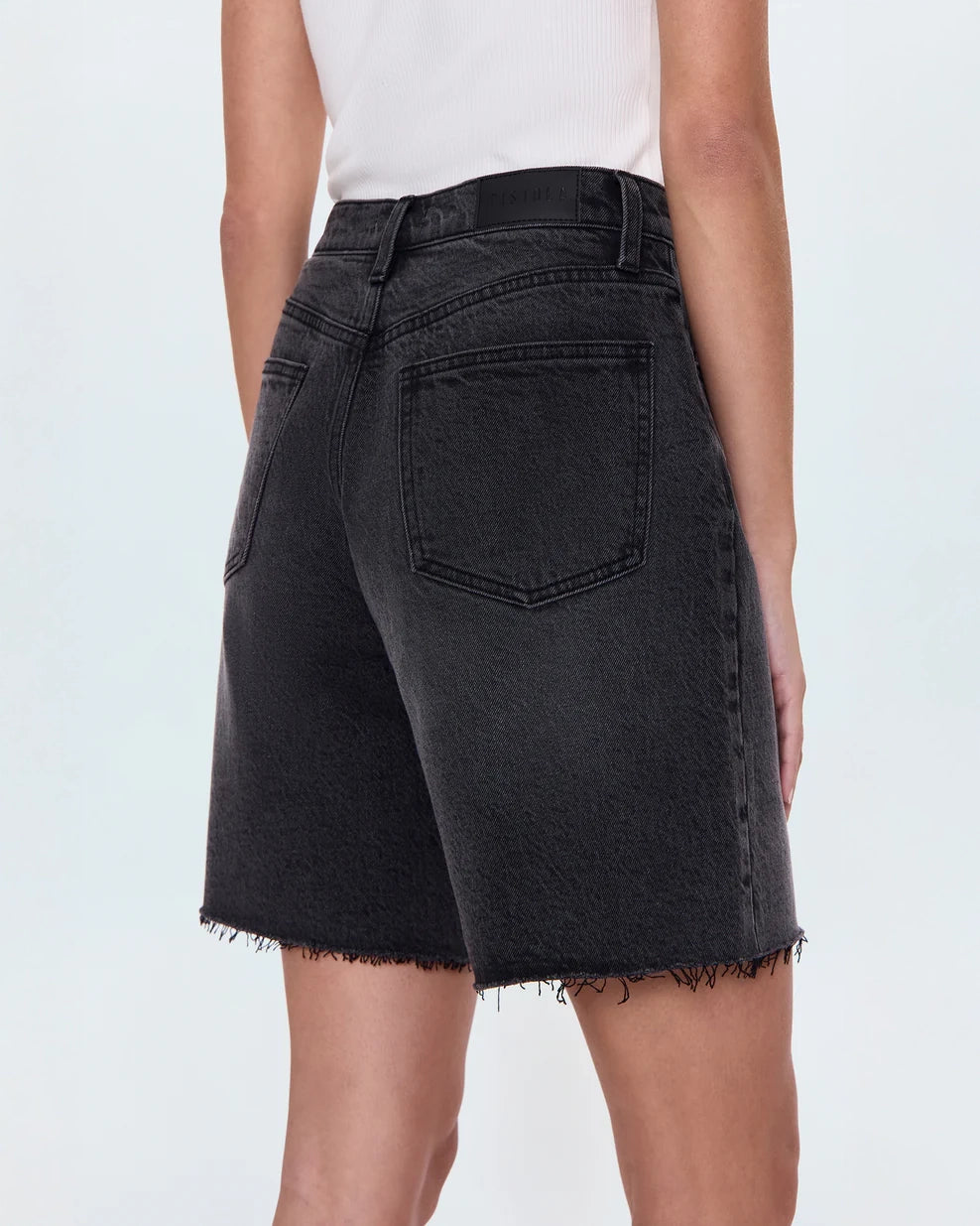 woman wearing black denim shorts