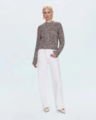 a woman wearing a cable knit fisherman sweater by Pistola