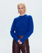 a woman wearing a cobalt blue alpaca crew neck sweater by Pistola