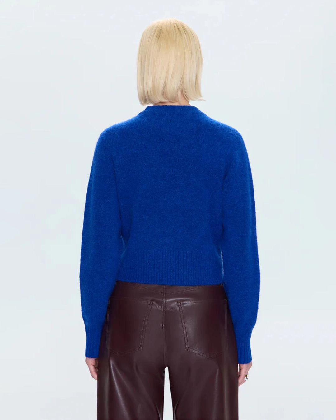 a woman wearing a cobalt blue alpaca crew neck sweater by Pistola