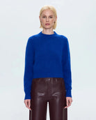 a woman wearing a cobalt blue alpaca crew neck sweater by Pistola
