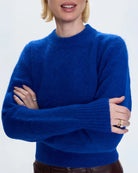 a woman wearing a cobalt blue alpaca crew neck sweater by Pistola