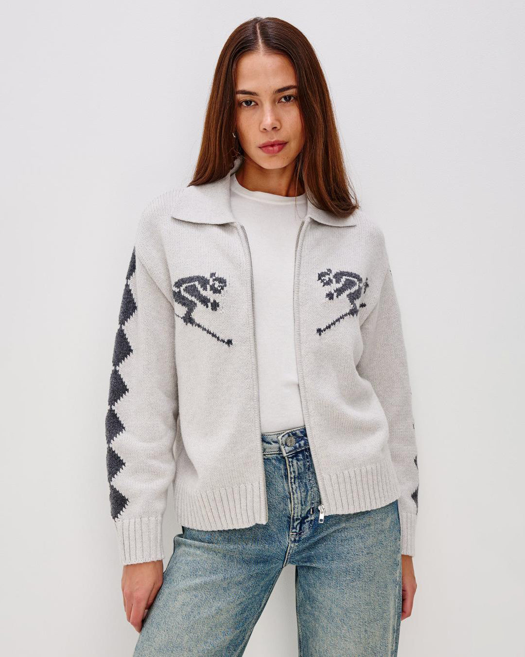Grey zip up sweater with two skiiers on the chest in blue
