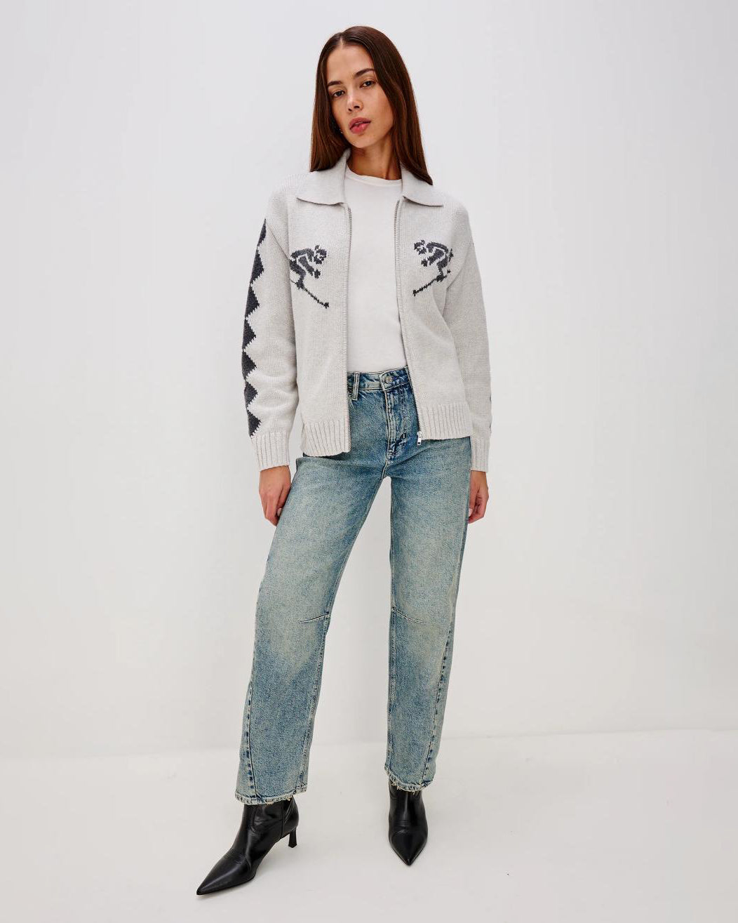 Grey zip up sweater with two skiiers on the chest in blue