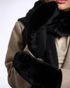woman wearing faux fur knitted mitten gloves in black