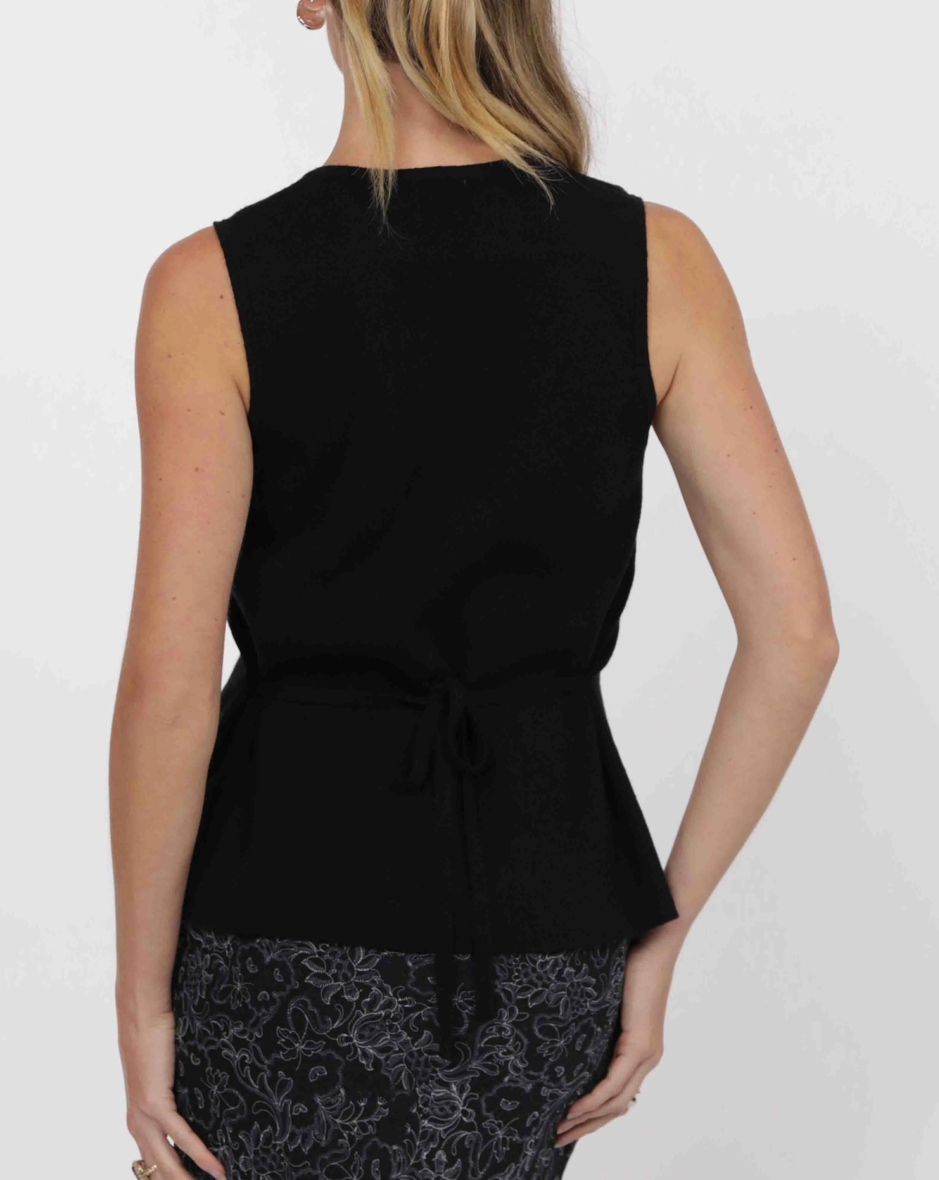 woman wearing knit button down vest in black