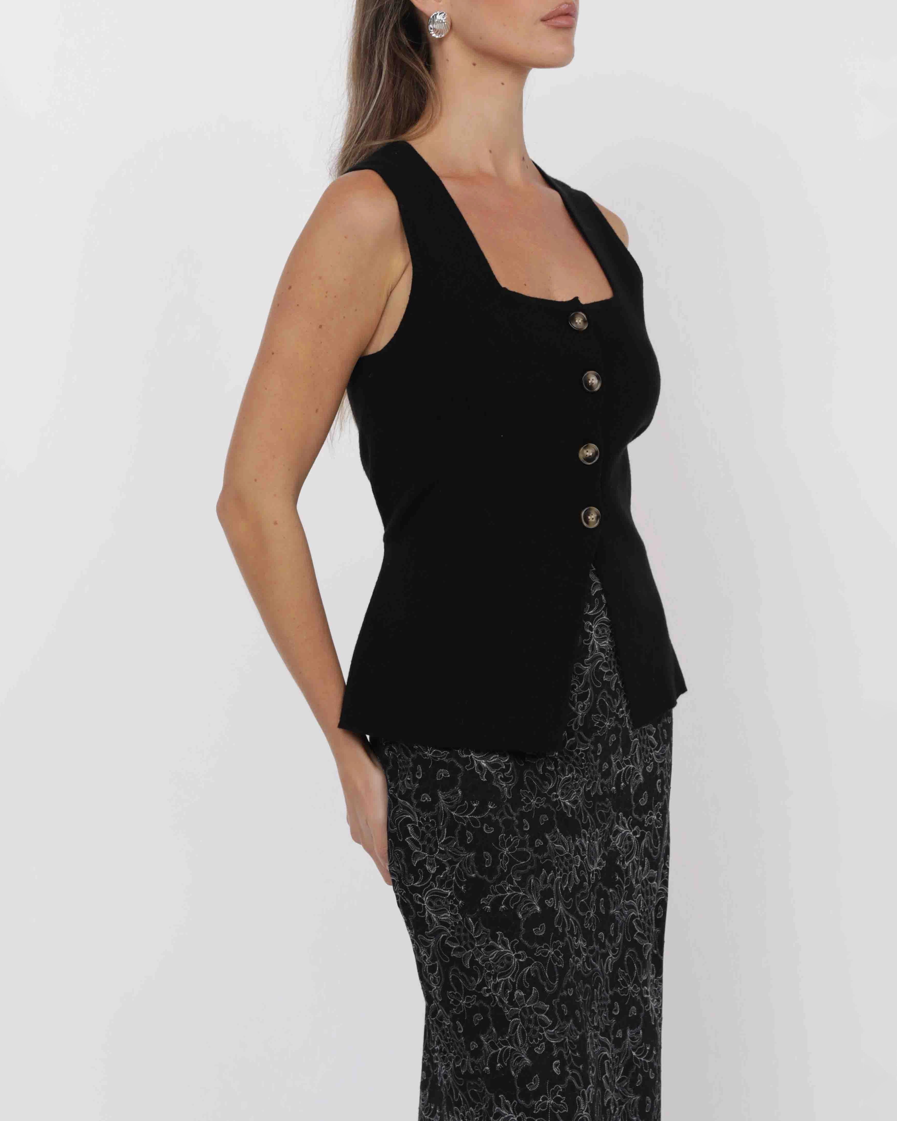 woman wearing knit button down vest in black