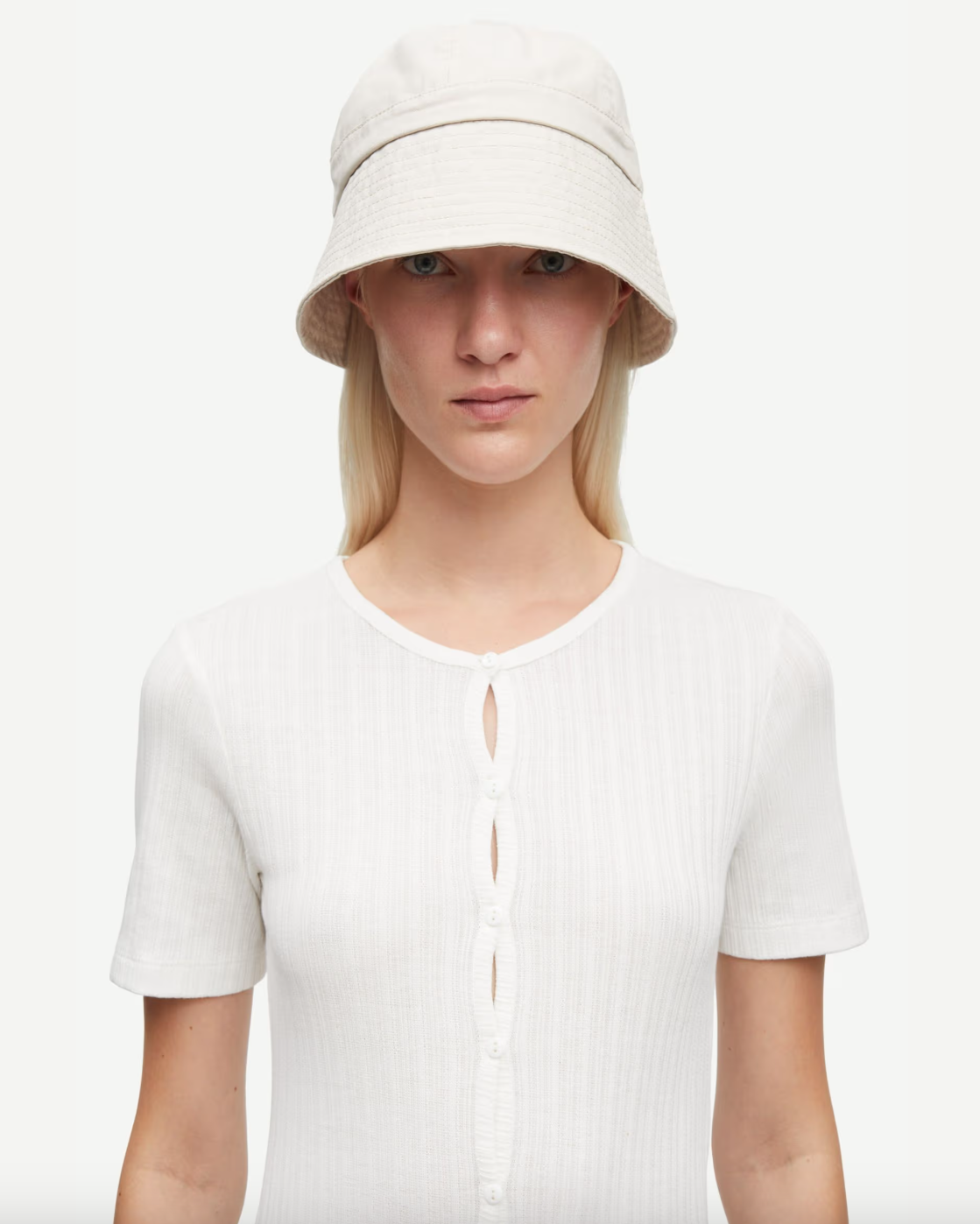 Woman wearing a white short-sleeve button down cardigan top