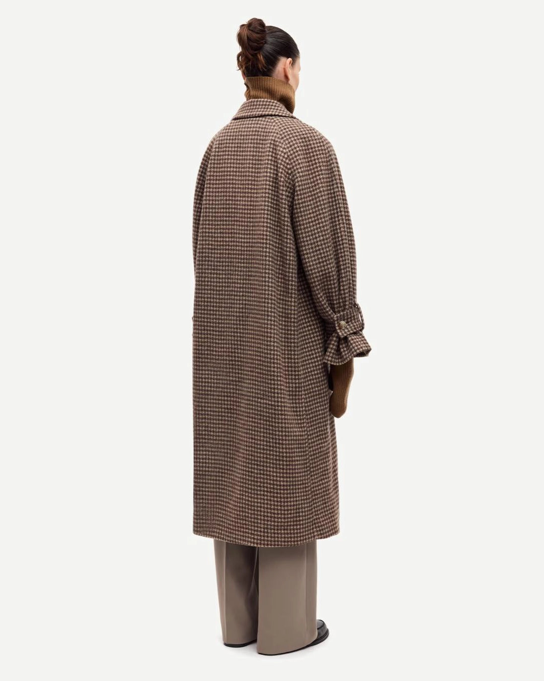 a woman wearing a long brown checked coat by Samsoe Samsoe