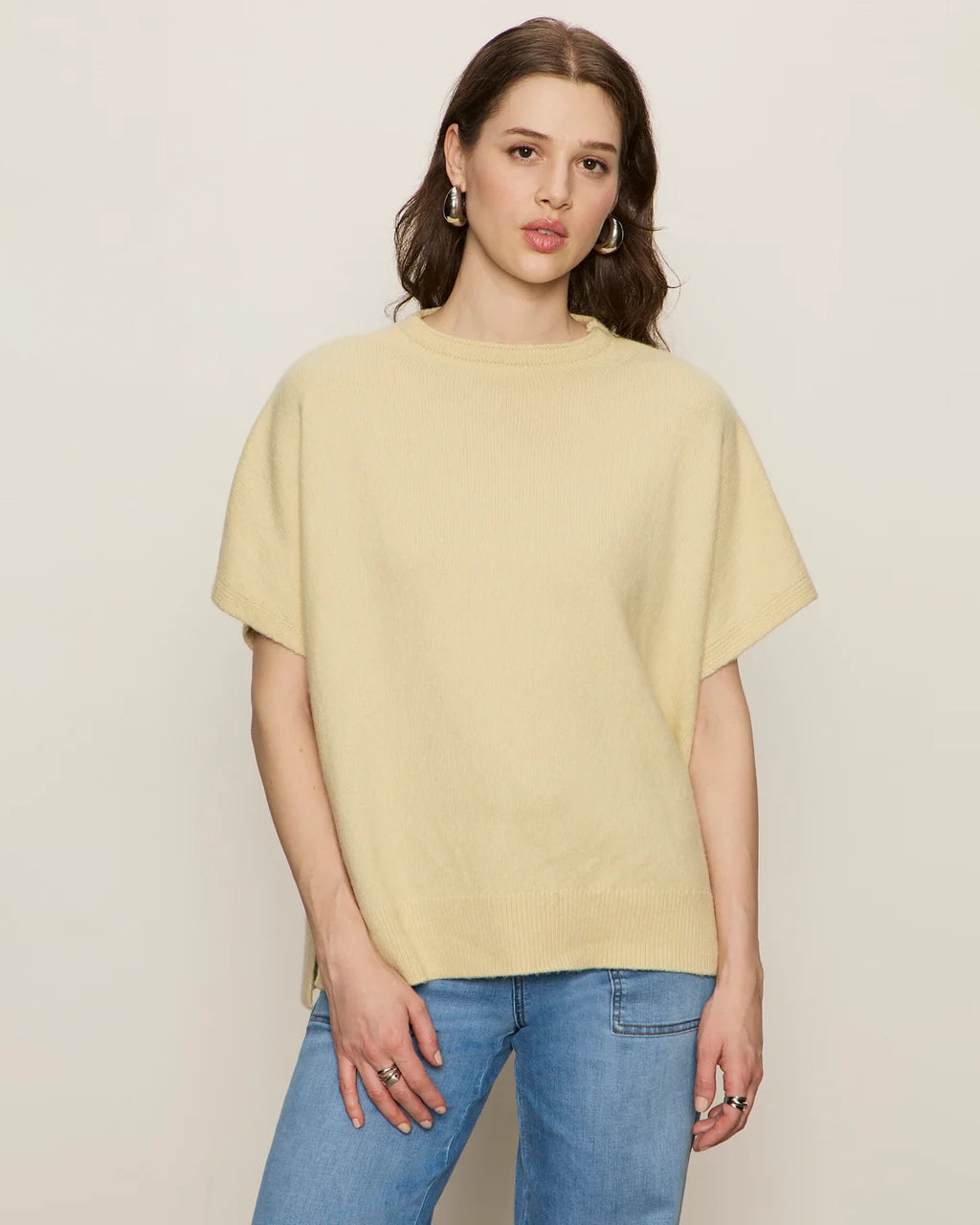 Woman wearing a light yellow oversized cashmere tee sweater
