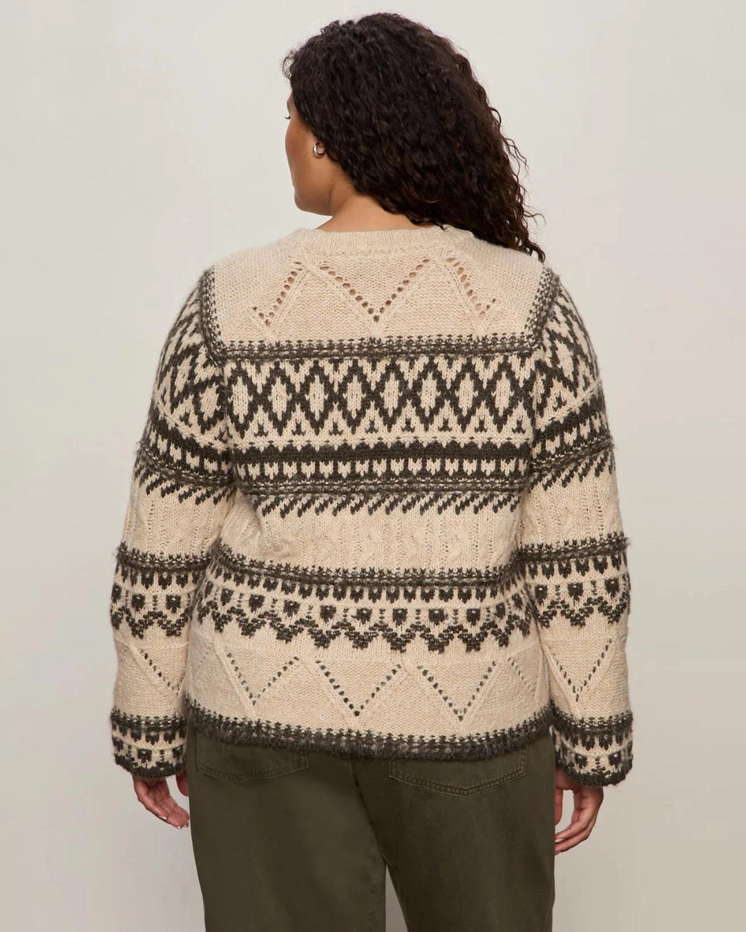 woman wearing a fairisle sweater in khaki green and cream