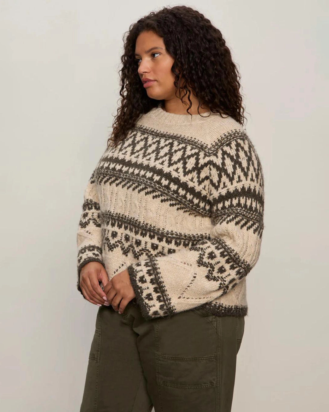 woman wearing a fairisle sweater in khaki green and cream