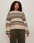 woman wearing a fairisle sweater in khaki green and cream