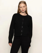 Woman wearing a black button down cardigan