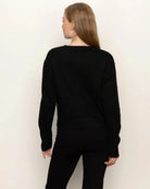 Woman wearing a black button down cardigan