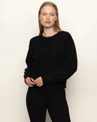 Woman wearing a black button down cardigan