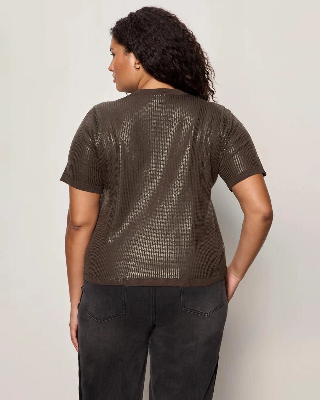 Woman wearing a sequin textured tshirt sweater in brown