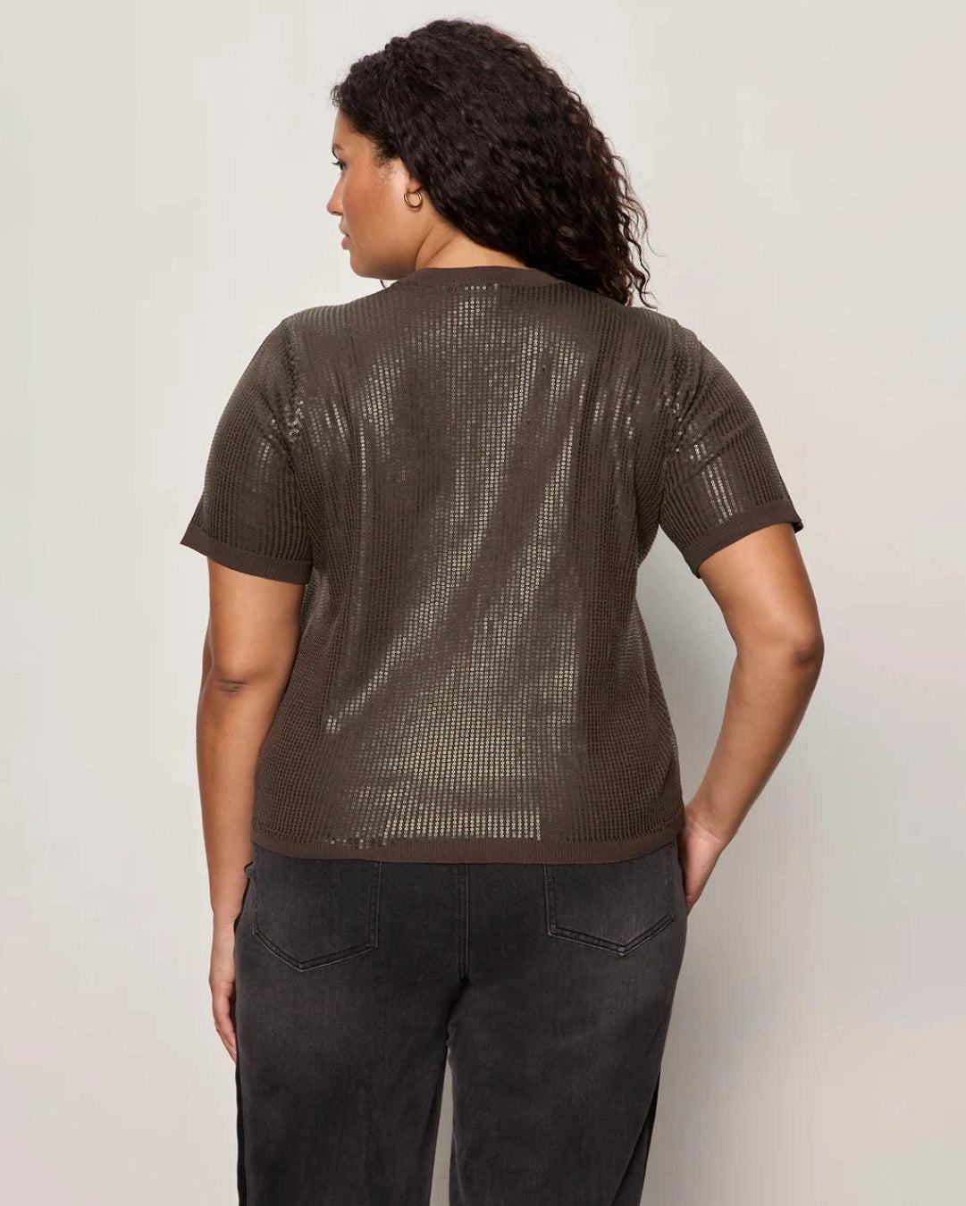 Woman wearing a sequin textured tshirt sweater in brown