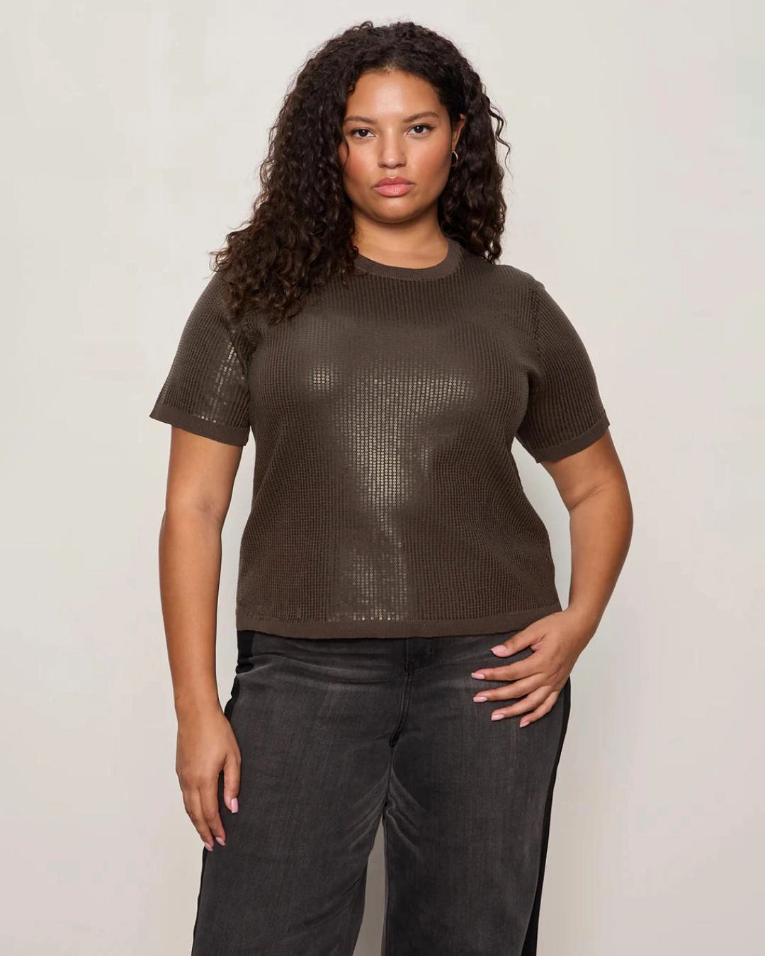 Woman wearing a sequin textured tshirt sweater in brown