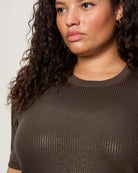 Woman wearing a sequin textured tshirt sweater in brown